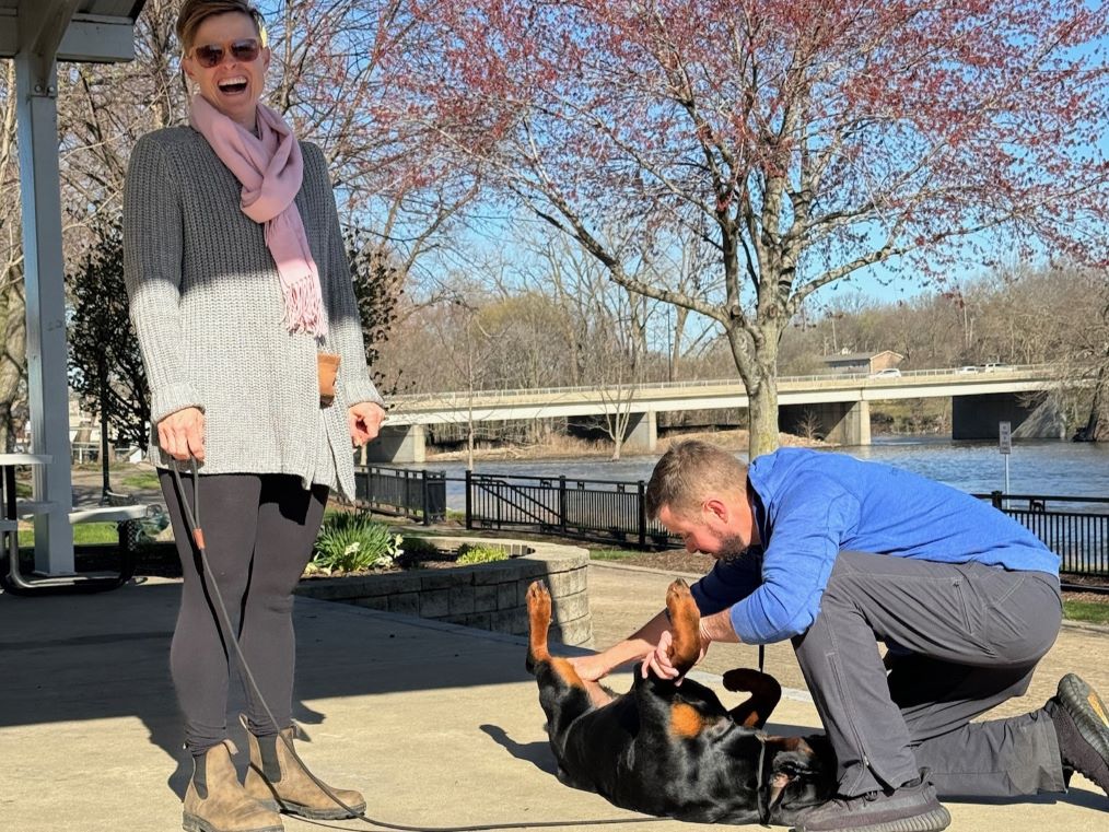 Cute-Pic-of-Lady-smiling-training-her-dog